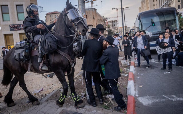 Ultra-Orthodox activists clash with police during a protest against the drafting of Haredi Jews to the IDF, in Jerusalem, May 23, 2024. (Chaim Goldberg/Flash90) Ultra-Orthodox activists clash with police during a protest against the drafting of Haredi Jews to the IDF, in Jerusalem, May 23, 2024. (Chaim Goldberg/Flash90)