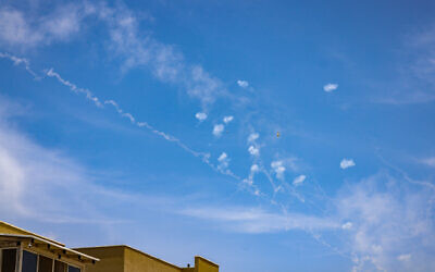 Smoke trails left after the Iron Dome air defense system intercepted rockets fired at Israel from Lebanon, as seen from the northern city of Safed, May 23, 2024. (David Cohen/Flash90)