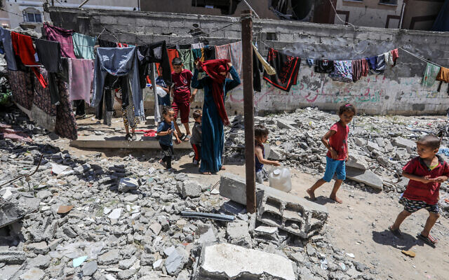 Palestinians who fled from the fighting in Rafah live in houses destroyed by Israeli airstrikes in Deir al-Balah, in the central Gaza Strip, on May 30, 2024. (Abed Rahim Khatib/Flash90)
