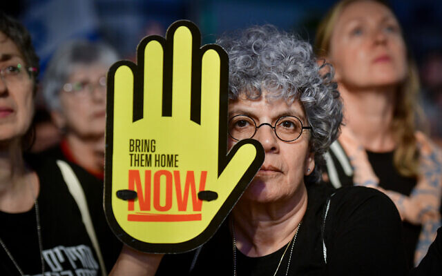 A woman holds a sign that reads, 'Bring them home now,' in Tel Aviv, May 4, 2024 (Avshalom Sassoni/Flash90) A woman holds a sign that reads, 'Bring them home now,' in Tel Aviv, May 4, 2024 (Avshalom Sassoni/Flash90)