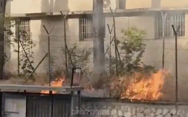 In this photo taken from a video, a fire lit by extremists can be seen on the grounds of the UNRWA headquarters in East Jerusalem, May 9, 2024. (Screenshot, Twitter; used in accordance with Clause 27a of the Copyright Law) In this photo taken from a video, a fire lit by extremists can be seen on the grounds of the UNRWA headquarters in East Jerusalem, May 9, 2024. (Screenshot, Twitter; used in accordance with Clause 27a of the Copyright Law)