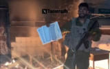 An IDF soldier seen throwing a Quran into a fire in Gaza. (X screengrab)