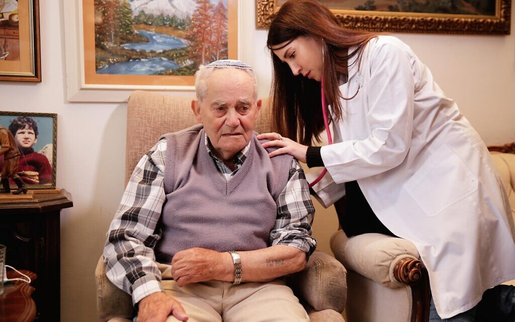 Dr. Tamara Kolitz, an endocrinologist from Tel Aviv-Sourasky Medical Center cares for a Holocaust survivor in his home. (Courtesy of LeMa'anam)