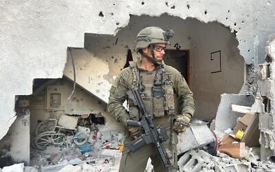 Battalion 202 commander Lt. Col. Almog Rotem stands in front of the home containing the tunnel shaft in which the bodies of four Israeli hostages – Itzhak Gelerenter, Amit Buskila, Ron Benjamin and Shani Louk – were found, May 22, 2024. (Lazar Berman/Times of Israel)