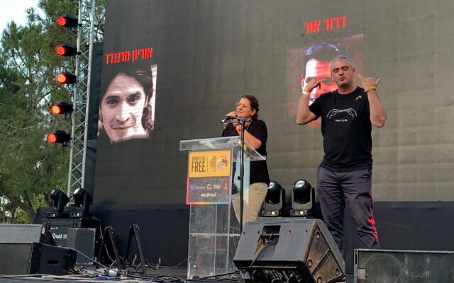 Hostage family member Ayala Metzger speaks to crowd at Jerusalem pride parade in Independence Park on May 30, 2024. (Charlie Summers/Times of Israel)