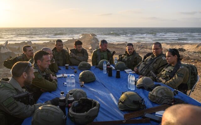 IDF Chief of Staff Lt. Gen. Herzi Halevi (left) speaks with reservist officers on the coast of the central Gaza Strip, May 3, 2024. (Israel Defense Forces) IDF Chief of Staff Lt. Gen. Herzi Halevi (left) speaks with reservist officers on the coast of the central Gaza Strip, May 3, 2024. (Israel Defense Forces)