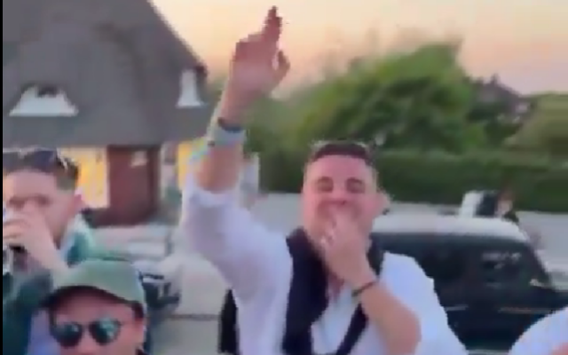 Screenshot of a man performing an apparent Nazi salute and Hitler mustache while chanting a Nazi slogan in Sylt, Germany, May 19, 2024. (X, used in accordance with Clause 27a of the Copyright Law) Screenshot of a man performing an apparent Nazi salute and Hitler mustache while chanting a Nazi slogan in Sylt, Germany, May 19, 2024. (X, used in accordance with Clause 27a of the Copyright Law)