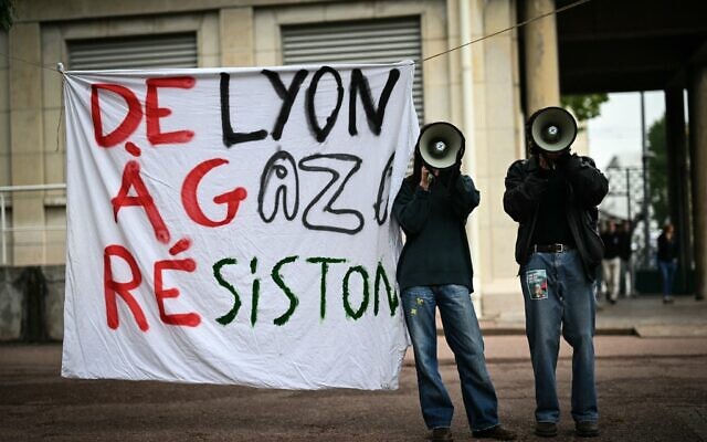 File: Demonstrators use megaphones next to a banner reading in French "From Lyon to Gaza, let's resist!" during aprotest action in the courtyard of the Institute of Political Studies (Sciences Po) building in Lyon, central Eastern France, on April 30, 2024. (Photo by OLIVIER CHASSIGNOLE / AFP)