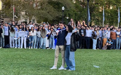 Columbia University students Eden Yadegar and Elisha H. Baker lead songs in support of Israel on October 12, 2023, at the Columbia University campus in New York. (courtesy)