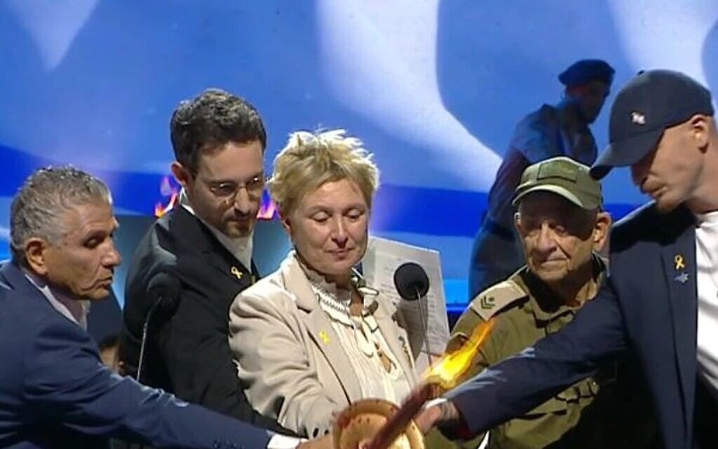 Torchlighters at a prerecorded state ceremony on the eve of Israel's 76th Independence Day, May 13, 2024. At center is Iris Haim, whose son Yotam, taken hostage by Hamas on October 7, was killed in error by IDF forces on December 15, along with Alon Shamriz and Samar Talalka, after they had escaped their captors. (GPO screenshot)
