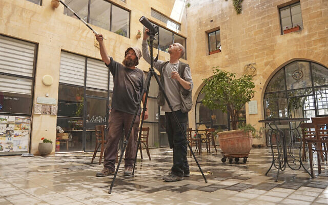 Shai Halevy and Michael Chernin of the Israel Antiquities Authority during research on the coats of arms at the Mt. Zion Hotel. (courtesy/IAA)