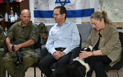 President Isaac Herzog (C) and his wife Michal Herzog (R, petting dog) meet with the first response team of Kibbutz Hanita in northern Israel, June 25, 2024. (Maayan Toaf/GPO) President Isaac Herzog (C) and his wife Michal Herzog (R, petting dog) meet with the first response team of Kibbutz Hanita in northern Israel, June 25, 2024. (Maayan Toaf/GPO)