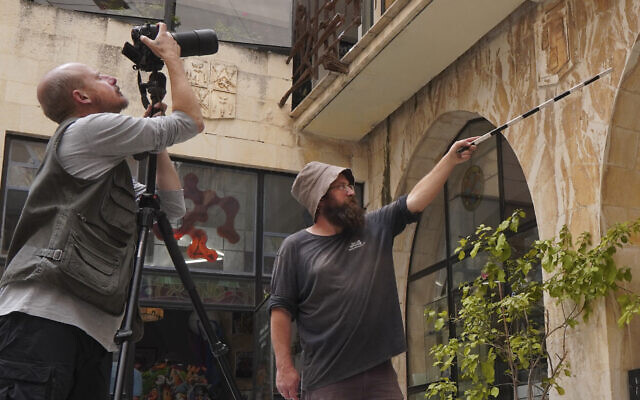 Shai Halevy and Michael Chernin of the Israel Antiquities Authority during research on the coats of arms at the Mt. Zion Hotel. (courtesy/IAA)