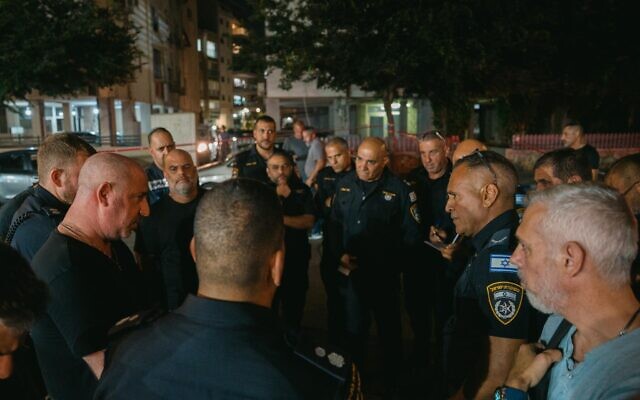 Israel Police officers from the Ayalon District Police hold an assessment at the scene of a deadly shooting in Bat Yam, June 25, 2024. (Israel Police)