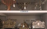 A collection of hanukkiot, Hanukkah candelabras, in the collection of Yad Vashem, including one dedicated on June 26, 2024 (Courtesy)