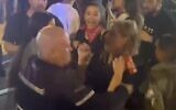A screenshot of video showing a police officer grabbing Channel 12 news reporter Yollan Cohen at an anti-government protest in Tel Aviv, June 22, 2024. (Screenshot: X, used in accordance with Clause 27a of the Copyright Law)