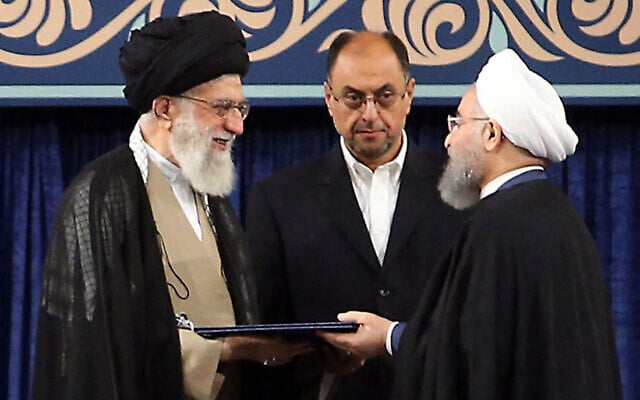A handout picture released by the official website of the Iranian supreme leader Ayatollah Ali Khamenei shows him (L) giving his official seal of approval during the swearing in ceremony of President Hassan Rouhani (R) to serve his second term, as deputy chief of supreme leader's office Vahid Haghanian (C) looks on in Tehran on August 3, 2017. (IRANIAN SUPREME LEADER'S WEBSITE / AFP) A handout picture released by the official website of the Iranian supreme leader Ayatollah Ali Khamenei shows him (L) giving his official seal of approval during the swearing in ceremony of President Hassan Rouhani (R) to serve his second term, as deputy chief of supreme leader's office Vahid Haghanian (C) looks on in Tehran on August 3, 2017. (IRANIAN SUPREME LEADER'S WEBSITE / AFP)