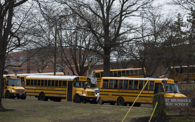 Illustrative: School buses drive from the campus of East Brunswick High School after the school day on February 22, 2018, in East Brunswick, New Jersey. (DOMINICK REUTER / AFP) Illustrative: School buses drive from the campus of East Brunswick High School after the school day on February 22, 2018, in East Brunswick, New Jersey. (DOMINICK REUTER / AFP)