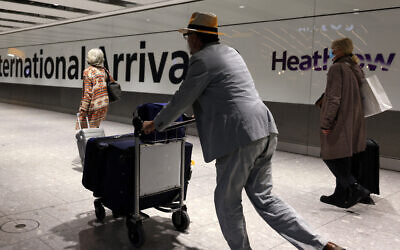 Illustrative: People arrive at Heathrow's Terminal 5 in west London on November 30, 2021. (Adrian DENNIS / AFP)