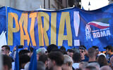 Illustrative: Members of National Youth, the youth wing of the Brothers of Italy party, hold a banner reading "Homeland" as they attend a joint rally of Italy's right-wing parties at Piazza del Popolo in Rome, September 22, 2022. (Andreas Solaro/AFP)