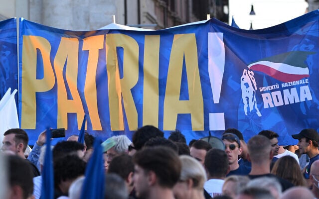 Illustrative: Members of National Youth, the youth wing of the Brothers of Italy party, hold a banner reading "Homeland" as they attend a joint rally of Italy's right-wing parties at Piazza del Popolo in Rome, September 22, 2022. (Andreas Solaro/AFP) Illustrative: Members of National Youth, the youth wing of the Brothers of Italy party, hold a banner reading "Homeland" as they attend a joint rally of Italy's right-wing parties at Piazza del Popolo in Rome, September 22, 2022. (Andreas Solaro/AFP)