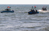 Members of the Yemeni Coast Guard affiliated with the Houthi group patrol the sea as demonstrators march through the Red Sea port city of Hodeida in solidarity with the people of Gaza amid the Israel-Hamas war, on January 4, 2024 (AFP)