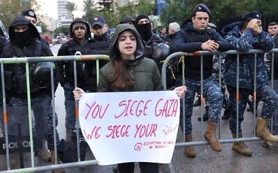 Lebanese security forces block the road leading to the Egyptian embassy in Beirut during a protest against the closure of the Rafah crossing between Egypt and the Gaza Strip, on February 19, 2024. (Anwar Amro/AFP)