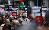 Palestinian photojournalist Motaz Azaiza (C) joins anti-Israel protesters preparing to march through central London, on May 18, 2024. (Photo by BENJAMIN CREMEL / AFP)