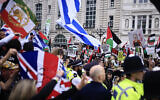 Illustrative: Protesters wave Israeli and UK flags as a pro-Palestinian rally marches past, in central London, May 18, 2024. (Benjamin Cremel / AFP)