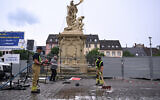 Members of the fire brigade clean away the blood at the scene where several people were injured in a knife attack on May 31, 2024, in Mannheim, western Germany. (Kirill Kudryavtsev/AFP)