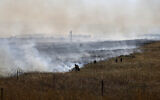 Israeli firefighters put out flames in a field after rockets launched from Lebanon struck the outskirts of Katzrin in the Golan Heights on June 2, 2024. (Jalaa Marey/AFP)