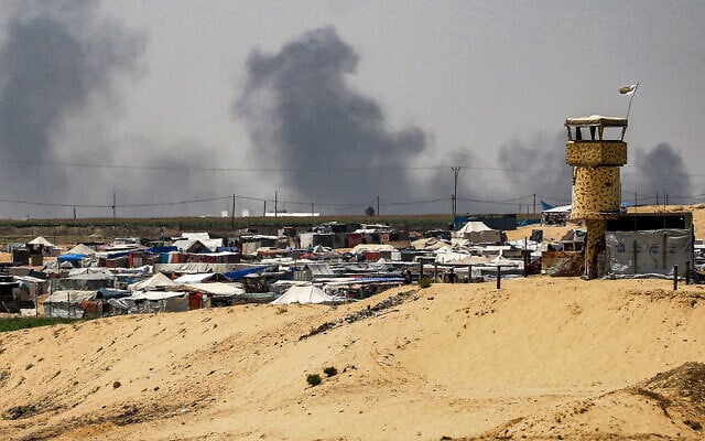 Smoke plumes billow near tents sheltering displaced Palestinians in Rafah in the southern Gaza Strip on June 4, 2024. (Eyad Baba/AFP)
