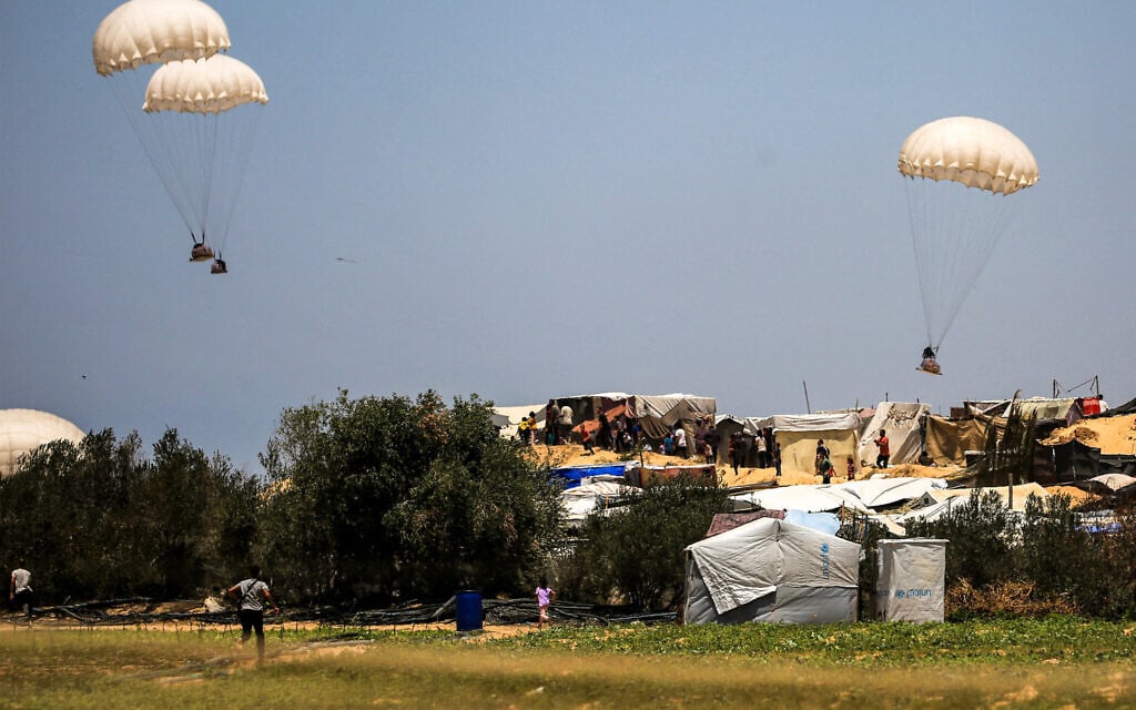 Humanitarian aid dropped on Khan Yunis falls near tents sheltering Palestinians displaced by conflict in the southern Gaza Strip on June 4, 2024. ( Eyad BABA / AFP)
