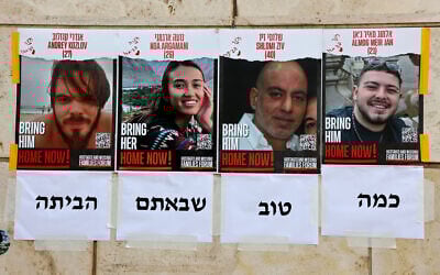 Posters depicting the portraits of rescued Israeli hostages Andrey Kozlov, 27, Noa Argamani, 26, Shlomi Ziv, 41, and Almog Meir Jan, 22, are plastered on a wall in Tel Aviv on June 8, 2024. The text underneath reads 'it's so good you came home.' (Gil Cohen-Magen/AFP)