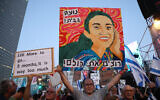 Artist Zeev Engelmayer holds his painting depicting Noa Argamani, one of four hostages rescued by the Israeli army, as activists rally in Tel Aviv, on June 8, 2024. (Jack Guez / AFP)