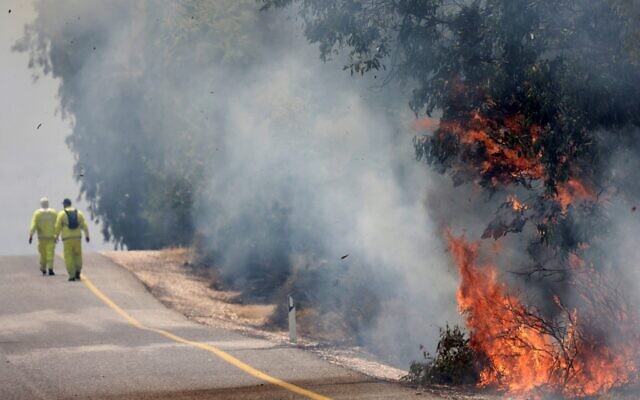 Israeli firefighters battle flames in a field in the Banias area of the Golan Heights sparked by rockets launched from southern Lebanon on June 9, 2024. (Jalaa MAREY / AFP) Israeli firefighters battle flames in a field in the Banias area of the Golan Heights sparked by rockets launched from southern Lebanon on June 9, 2024. (Jalaa MAREY / AFP)