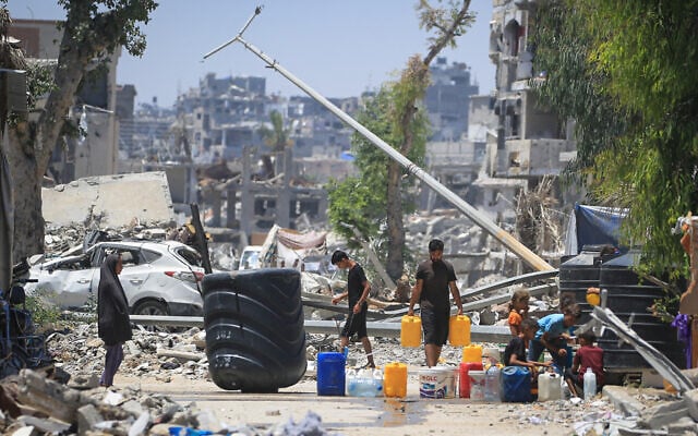 Palestinians collect water near buildings destroyed in Israeli strikes on Khan Younis in the southern Gaza Strip on June 11, 2024. (Eyad Baba/AFP) Palestinians collect water near buildings destroyed in Israeli strikes on Khan Younis in the southern Gaza Strip on June 11, 2024. (Eyad Baba/AFP)