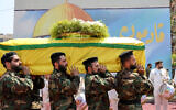 The coffin of Taleb Abdallah, known as Abu Taleb, a senior field commander of Hezbollah who was killed in what security forces say was an Israel strike, is carried during his funeral in Beirut's southern suburbs on June 12, 2024. (Anwar Amro / AFP)