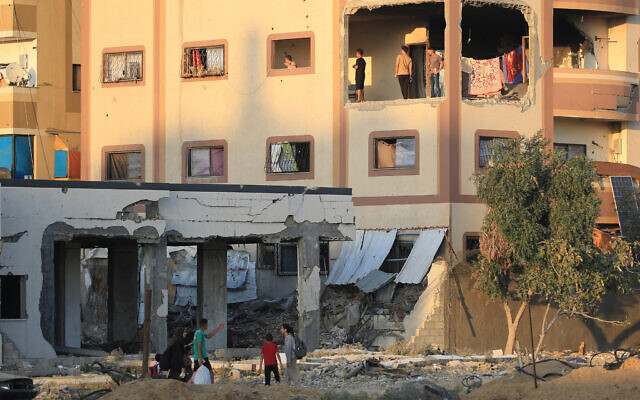 Displaced Palestinians gather in a damaged building used as a temporary shelter in al-Bureij refugee camp in the central Gaza Strip on June 12, 2024, amid the ongoing conflict between Israel and Hamas. (Photo by Eyad BABA / AFP) Displaced Palestinians gather in a damaged building used as a temporary shelter in al-Bureij refugee camp in the central Gaza Strip on June 12, 2024, amid the ongoing conflict between Israel and Hamas. (Photo by Eyad BABA / AFP)
