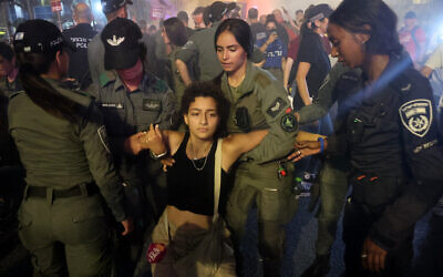 A protester is detained during protests calling for a hostage deal and denouncing the government, in Tel Aviv, on June 15, 2024. (JACK GUEZ / AFP)