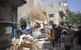 People search for survivors in the rubble of a building following Israeli bombardment at the Bureij refugee camp in the central Gaza Strip on June 16, 2024. (Eyad BABA / AFP)