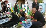 Relatives visit the graves of killed Hezbollah fighters during Eid al-Adha, or the Feast of Sacrifice in the southern Lebanese town of Naqoura near the border with Israel on June 17, 2024. (Photo by Mahmoud ZAYYAT / AFP)