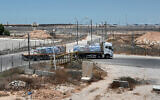A truck carrying humanitarian aid for the Gaza Strip passes through the Kerem Shalom border crossing between southern Israel and Gaza, on June 17, 2024. (Ahikam Seri/AFP)