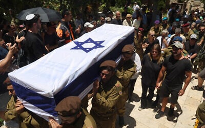 Soldiers carry the coffin of Sgt. First Class (res.) Omer Smadga, 25, who was killed the day before in a mortar strike in central Gaza, at the military cemetery in Netanya, June 21, 2024. (Jack Guez / AFP)