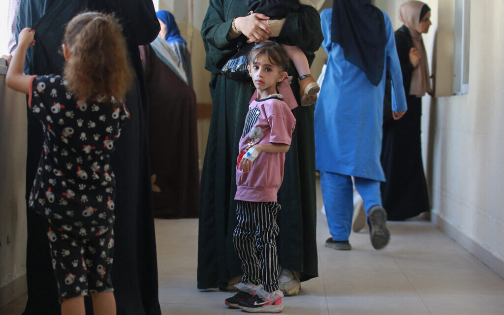 Palestinian children with serious illnesses wait with family members at Nasser hospital in Khan Younis in the southern Gaza Strip on June 24, 2024, after they reportedly were given permission by the Israeli army to leave for treatment through the Kerem Shalom Border Crossing for the first time since the outbreak of war. (Bashar Taleb/AFP)