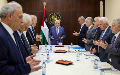 Palestinian Authority President Mahmoud Abbas (C) recites a prayer during a meeting with members of the executive committee of the Palestine Liberation Organisation (PLO) in the West Bank city of Ramallah on June 24, 2024. (Thaer Ghanaim / PPO / AFP)