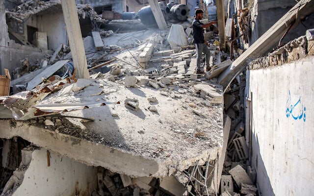 Men search through the rubble of the house of the sister of Ismail Haniyeh, the Doha-based political bureau chief of the Hamas, after it was hit by an alleged IDF strike in Gaza City's Shati camp, June 25, 2024. (Omar Al-Qattaa/AFP) Men search through the rubble of the house of the sister of Ismail Haniyeh, the Doha-based political bureau chief of the Hamas, after it was hit by an alleged IDF strike in Gaza City's Shati camp, June 25, 2024. (Omar Al-Qattaa/AFP)