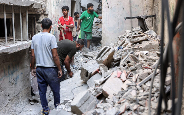 Men search through the rubble of the house of the sister of Ismail Haniyeh, the Doha-based political bureau chief of the Hamas terror group, after it was hit by an Israeli strike in the Shati camp west of Gaza City on June 25, 2024. (Omar Al-Qattaa/AFP) Men search through the rubble of the house of the sister of Ismail Haniyeh, the Doha-based political bureau chief of the Hamas terror group, after it was hit by an Israeli strike in the Shati camp west of Gaza City on June 25, 2024. (Omar Al-Qattaa/AFP)