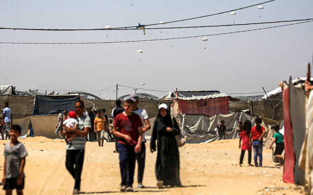Humanitarian aid packages are dropped on the Gaza Strip near Rafah on June 25, 2024. (Eyad Baba/AFP)