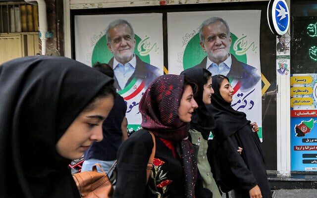 Women walk past election posters for Iranian reformist presidential candidate Massoud Pezeshkian along a street in Tehran on June 26, 2024 ahead of the vote. (RAHEB HOMAVANDI / AFP) Women walk past election posters for Iranian reformist presidential candidate Massoud Pezeshkian along a street in Tehran on June 26, 2024 ahead of the vote. (RAHEB HOMAVANDI / AFP)